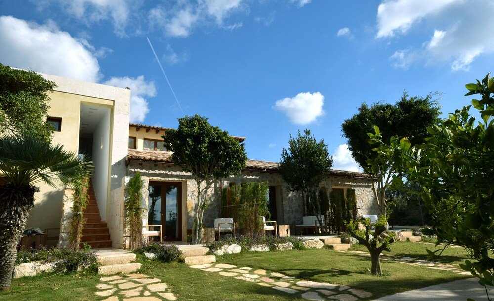 Modern house with a stone wall at Pula Golf Resort in Son Servera, Mallorca