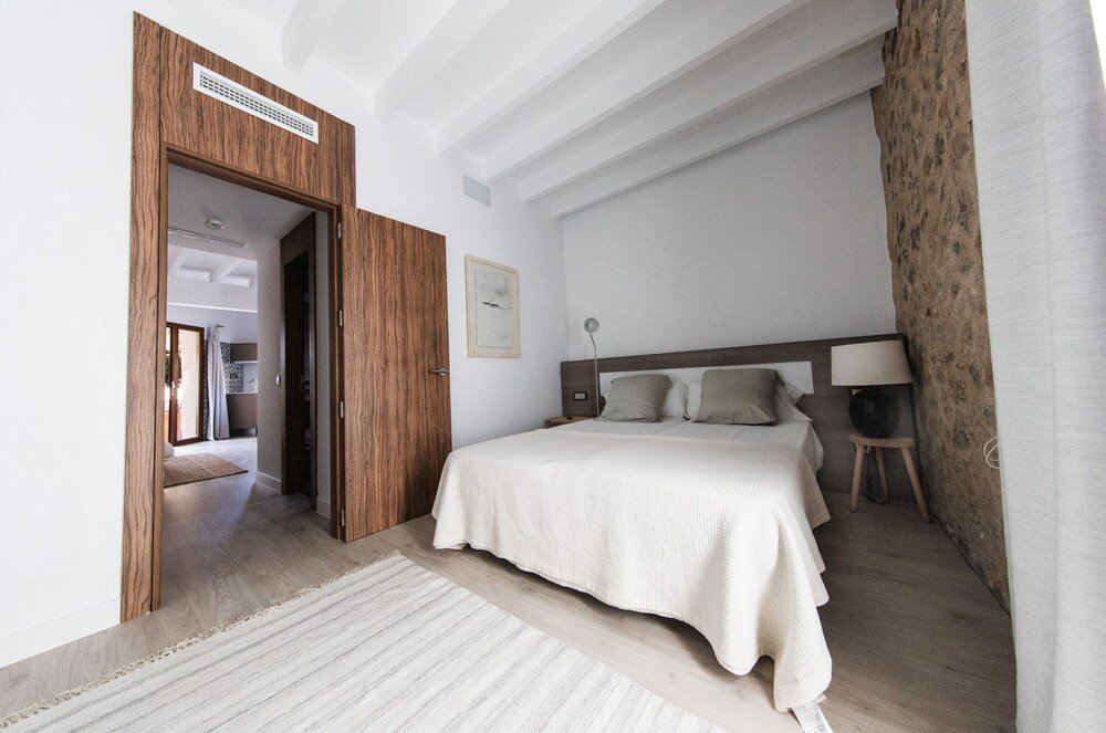 Bedroom with a wooden wall at Pula Golf Resort in Son Servera, Mallorca