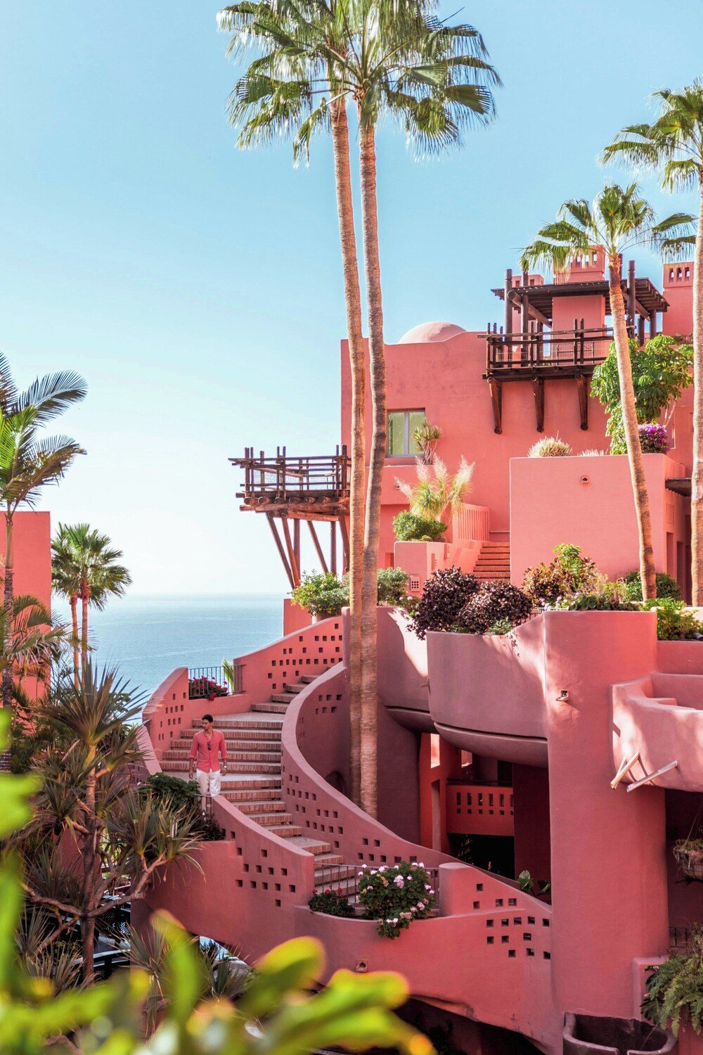 Pink resort building with a spiral staircase at The Ritz-Carlton, Abama
