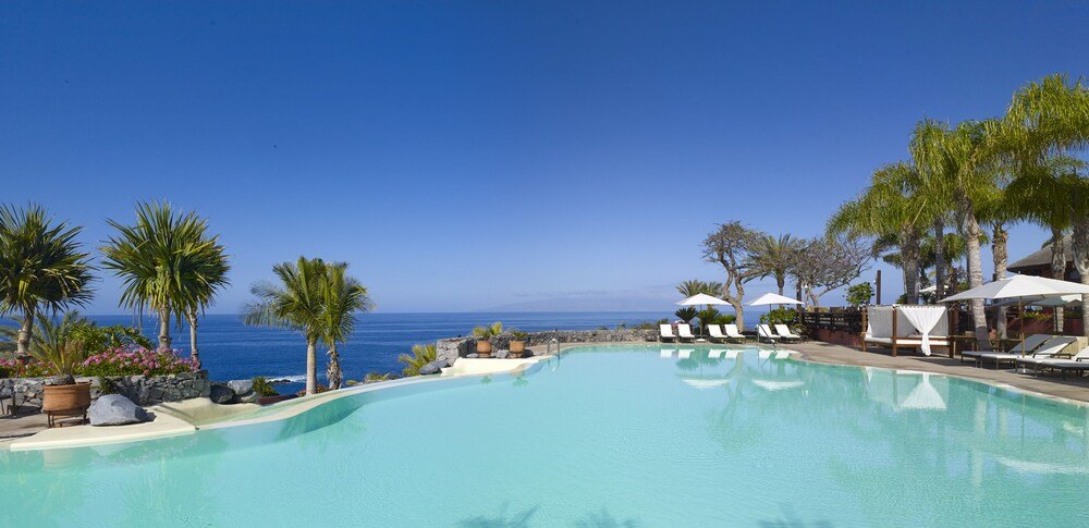 Resort pool with lounge chairs at The Ritz-Carlton Abama in Tenerife