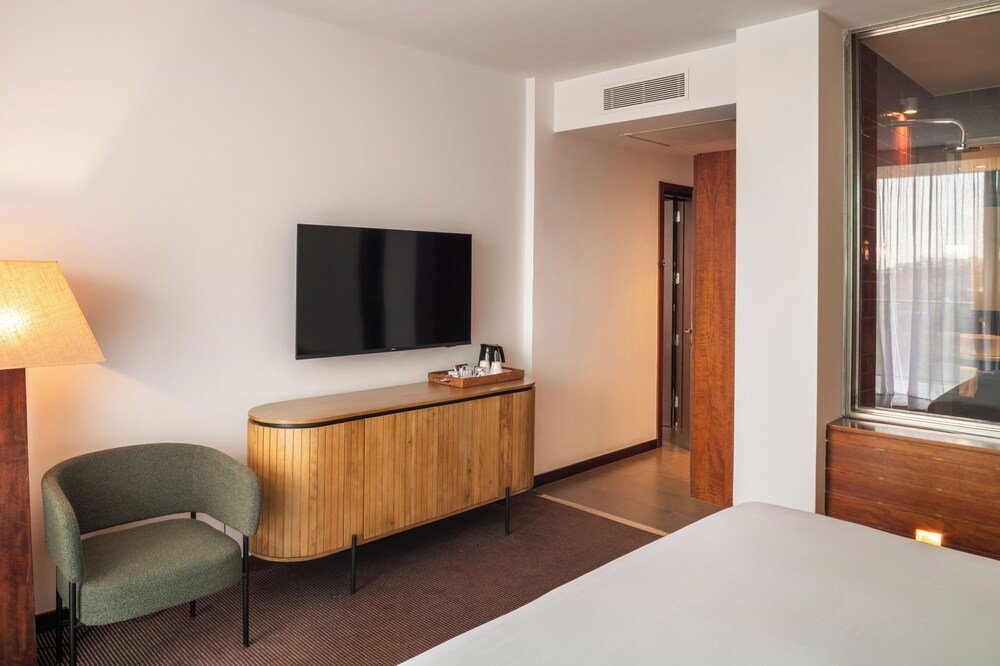 Guest room with a bed and seating at the Gran Canaria resort