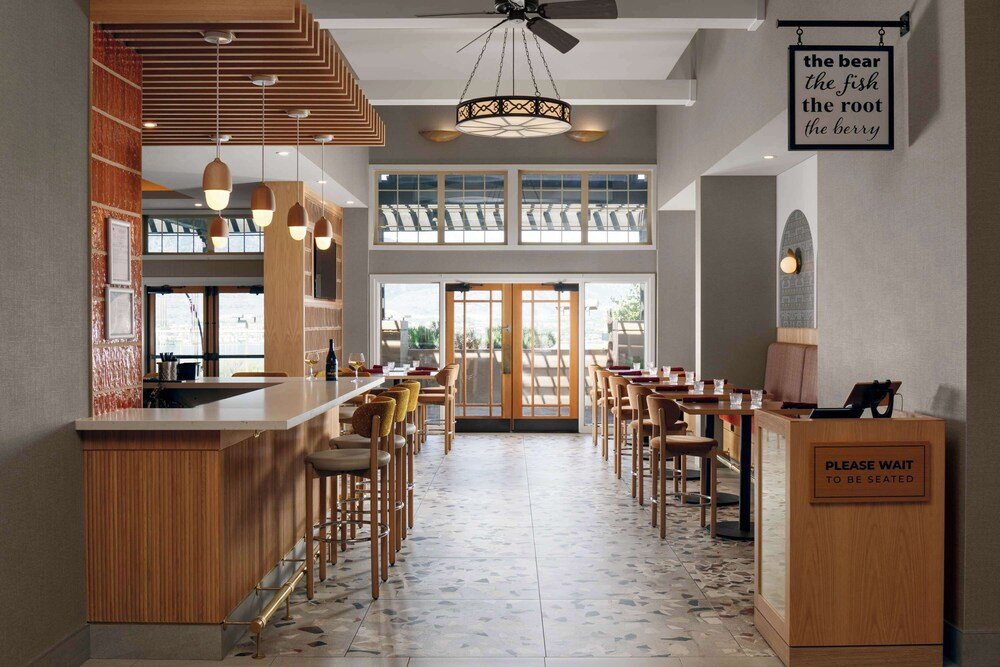 Restaurant with a bar area and high ceilings