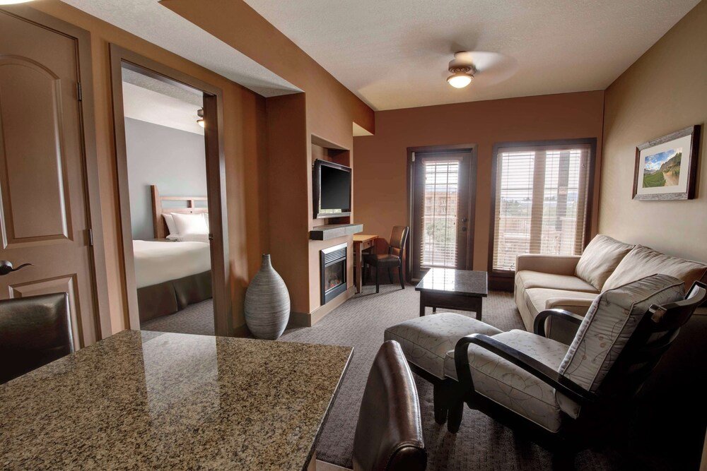 Hotel room with a bed, TV and fireplace