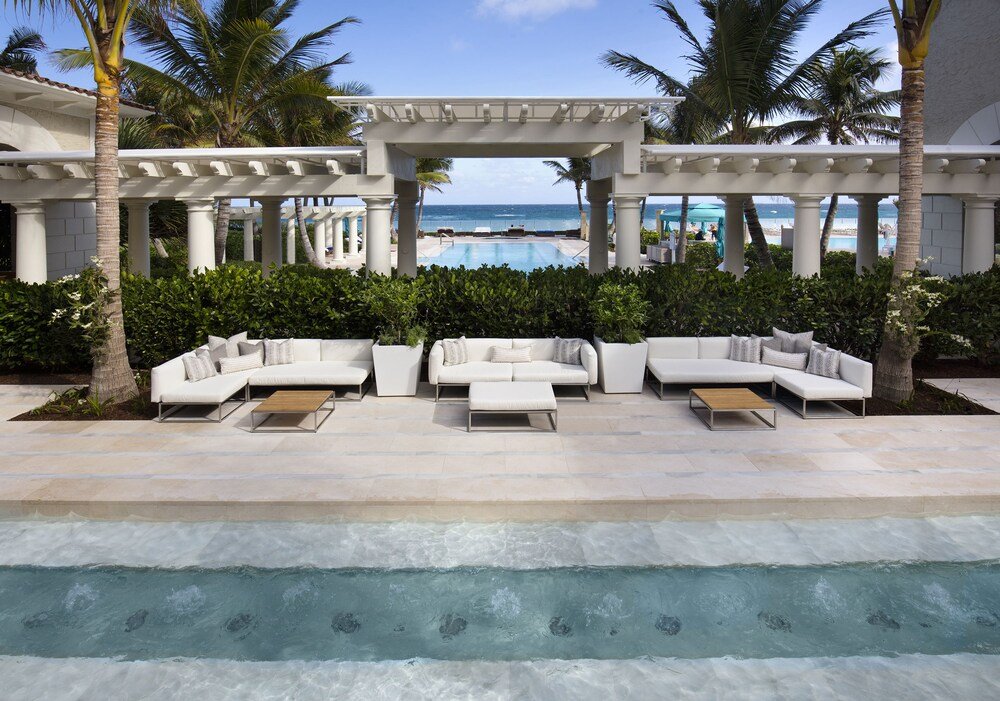Poolside area with white outdoor furniture
