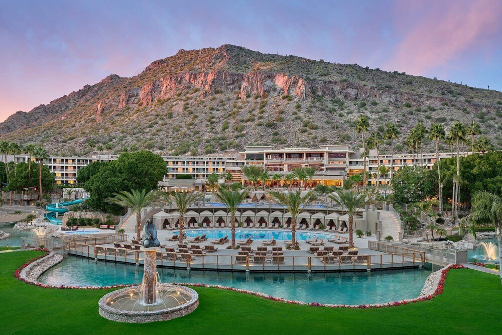 Resort with a large swimming pool and palm trees