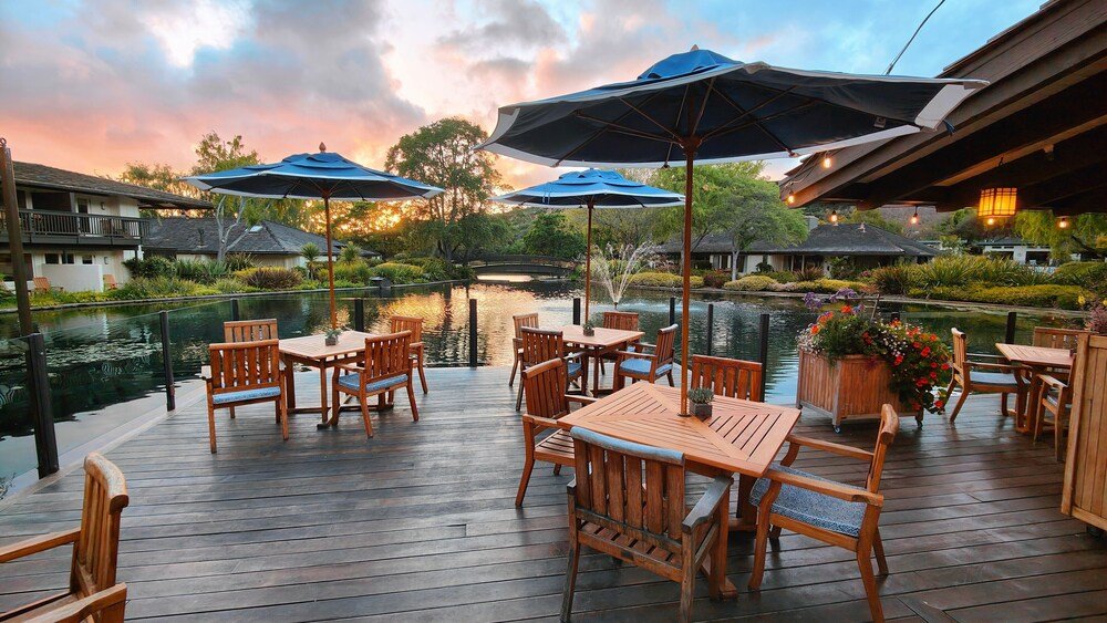 Wooden deck with tables, chairs and umbrellas at the resort