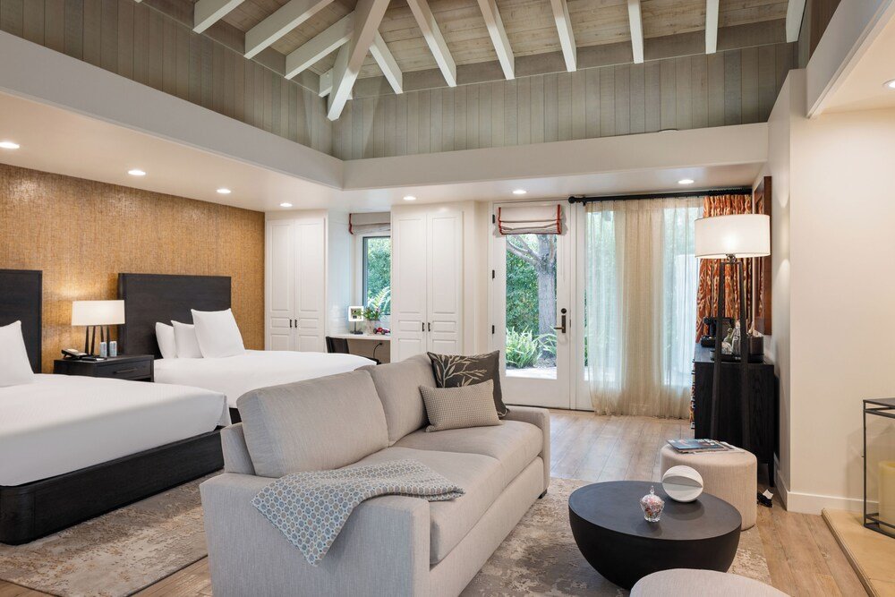 Modern bedroom with two beds and a sofa