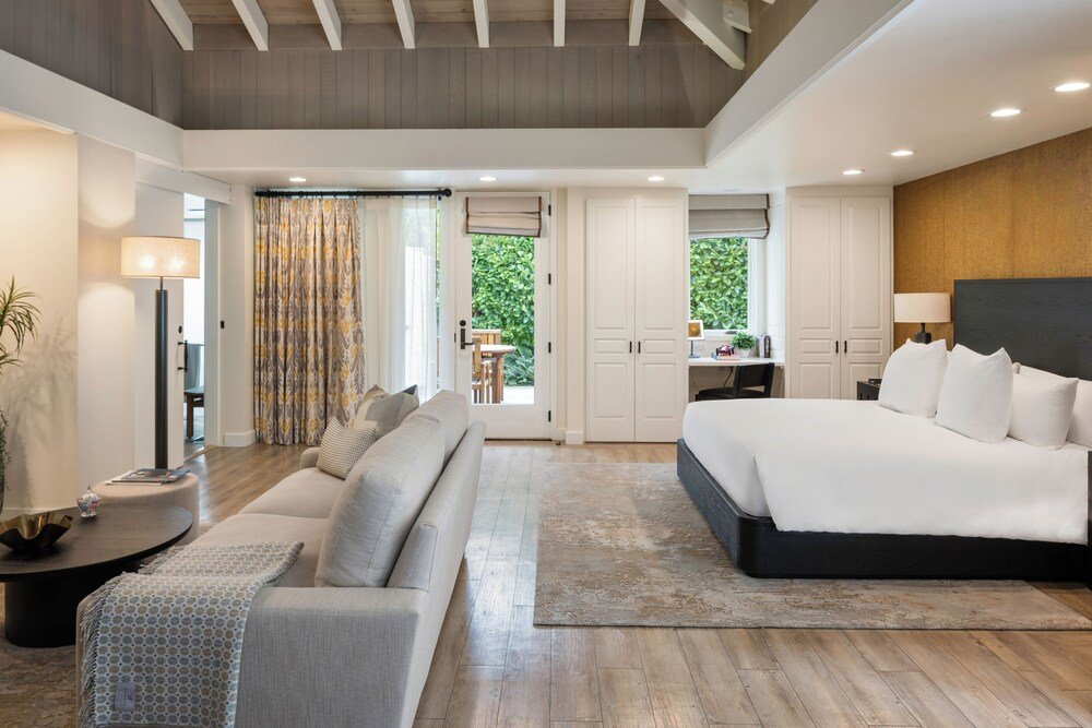 Modern bedroom with a large bed and a sofa