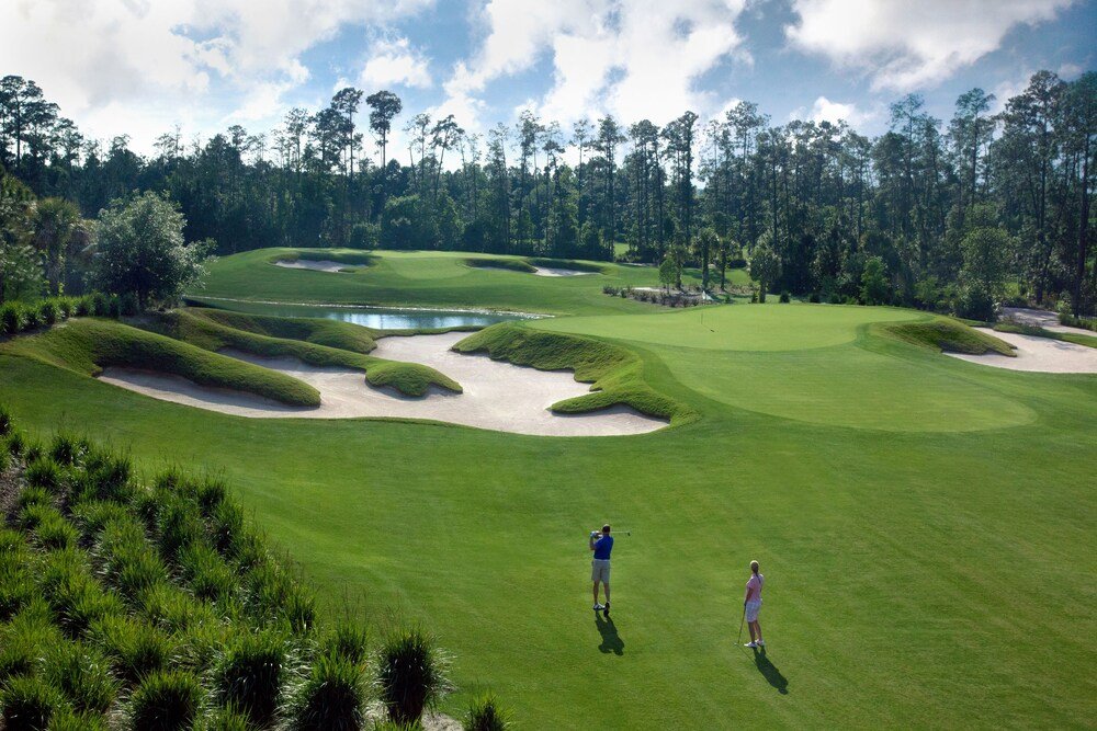 Golf course with sand bunkers and a pond