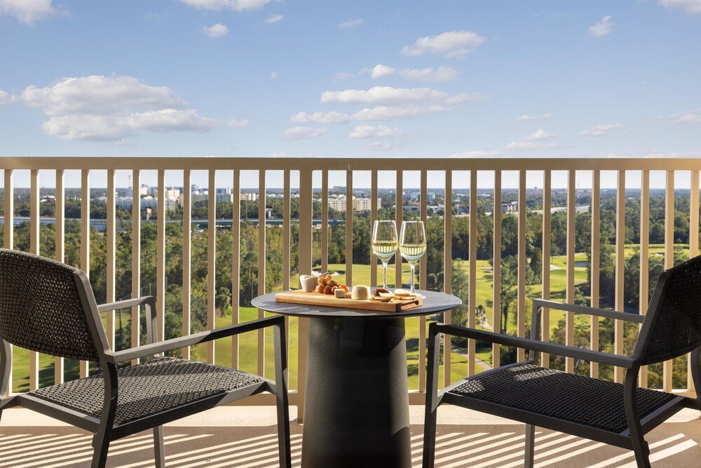 Balcony with two chairs and glasses of wine