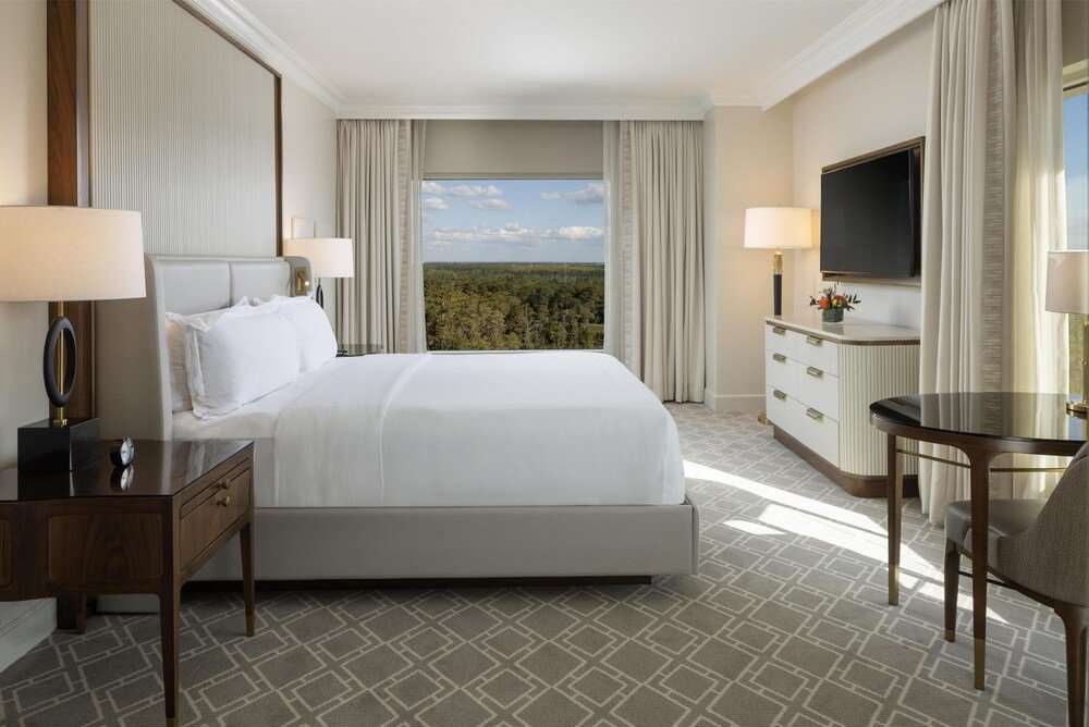 Guest room with a comfortable bed at Waldorf Astoria Orlando